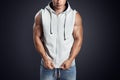 Handsome bodybuilder wearing gray sleeveless hoodie Royalty Free Stock Photo