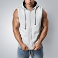 Handsome bodybuilder wearing gray sleeveless hoodie Royalty Free Stock Photo