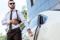 handsome bodyguard touching gun and opening Royalty Free Stock Photo