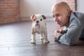 Handsome bold man with puppy english bulldog