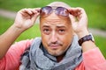 Handsome bold man wearing neck handkerchief resting outdoor