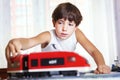 Handsome boy play with meccano toy train