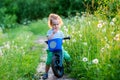 Handsome boy toddler in a meadow full of dandelions