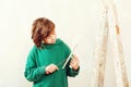 Handsome boy working with spatula. Home renovation. Cute son helps parents to repair room Royalty Free Stock Photo