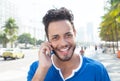 Handsome brazilian man at phone at city Royalty Free Stock Photo