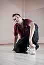 Handsome breakdancer sitting on the floor Royalty Free Stock Photo