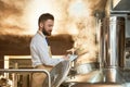 Brewery worker holding folder, inspecting brew process. Royalty Free Stock Photo