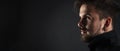 Handsome brutal guy with beard on dark background Royalty Free Stock Photo