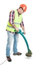 Handsome builder cutting grass with string trimmer Royalty Free Stock Photo