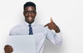 Handsome business black man holding blank empty banner pointing finger to one self smiling happy and proud Royalty Free Stock Photo