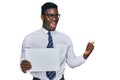 Handsome business black man holding blank empty banner pointing thumb up to the side smiling happy with open mouth Royalty Free Stock Photo