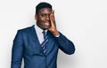 Handsome business black man wearing business suit and tie covering one eye with hand, confident smile on face and surprise emotion Royalty Free Stock Photo