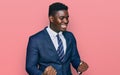 Handsome business black man wearing business suit and tie very happy and excited doing winner gesture with arms raised, smiling Royalty Free Stock Photo