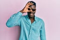 Handsome business black man wearing stylish sunglasses smiling happy doing ok sign with hand on eye looking through fingers Royalty Free Stock Photo