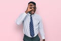 Handsome business black man wearing white shirt and tie smiling happy doing ok sign with hand on eye looking through fingers Royalty Free Stock Photo