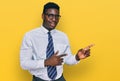 Handsome business black man wearing white shirt and tie smiling and looking at the camera pointing with two hands and fingers to Royalty Free Stock Photo