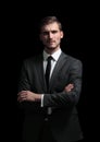 Handsome business man isolated on black with arms crossed Royalty Free Stock Photo