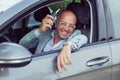 Handsome business man male holding car keys in hand showing his new car Royalty Free Stock Photo