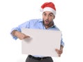 Handsome business man in santa christmas hat pointing blank billboard Royalty Free Stock Photo