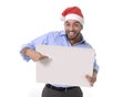 Handsome business man in santa christmas hat pointing blank billboard Royalty Free Stock Photo