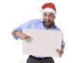 Handsome business man in santa christmas hat pointing blank billboard Royalty Free Stock Photo