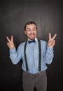 Handsome business man with victory gesture on blackboard Royalty Free Stock Photo