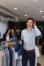 Handsome Business Man Wear Formal Suit Holding Jacket In Hands In Modern Menswear Shop