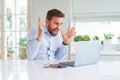 Handsome business man working using computer laptop very happy and excited, winner expression celebrating victory screaming with Royalty Free Stock Photo