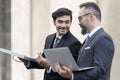 Handsome businessman and attractive Engineer talking and holding laptop and solar panel Royalty Free Stock Photo