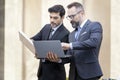 Handsome businessman and attractive Engineer talking and holding laptop and solar panel Royalty Free Stock Photo