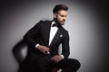 Handsome businessman in black tuxedo unbuttoning his suit Royalty Free Stock Photo