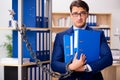 The handsome businessman chained to the office shelf