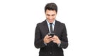 Handsome businessman checking emails and reading message on mobile phone