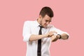 Handsome businessman checking his wrist-watch Isolated on pink background Royalty Free Stock Photo