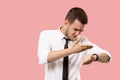 Handsome businessman checking his wrist-watch Isolated on pink background Royalty Free Stock Photo