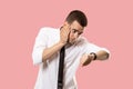 Handsome businessman checking his wrist-watch Isolated on pink background Royalty Free Stock Photo