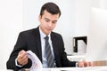 Handsome businessman concentrated on reading documents at his desk