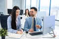 Handsome businessman confidently giving instructions to his female colleague, who taking notes in her notebook at office Royalty Free Stock Photo