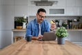 Handsome businessman doing online shopping over laptop with credit card at desk in home office Royalty Free Stock Photo