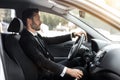 Handsome businessman driving car to airport, going on business trip Royalty Free Stock Photo