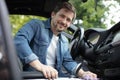 handsome businessman driving car to work