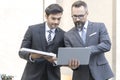 Handsome businessman and Engineer attractive. Businessman and attractive Engineer talking and holding laptop and solar panel at Royalty Free Stock Photo