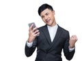 Handsome businessman feel excited while holding mobile phone with a fist in the other hand on white background