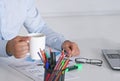 Handsome businessman having tea or coffee in office Royalty Free Stock Photo