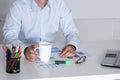 Handsome businessman having tea or coffee in office Royalty Free Stock Photo