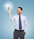 Handsome businessman holding light bulb Royalty Free Stock Photo