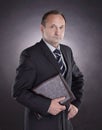 Handsome businessman with a leather folder .isolated on black