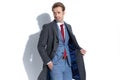 Handsome businessman looking away, fixing his coat Royalty Free Stock Photo