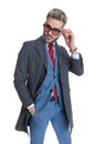 Handsome businessman looking away, fixing his sunglasses Royalty Free Stock Photo