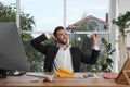 Handsome businessman playing with paper plane at desk in office Royalty Free Stock Photo